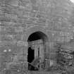 View from N showing small arched doorway on NNW front
