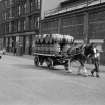 View from WNW showing horse lorry travelling along Stobcross Street with tenements and works in background