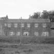 View from NE showing NE front of workshops and part of NE front of houses