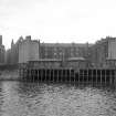 View from NE showing NE front of pier with tenements and part of platers shed in background