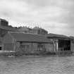 View from SSW showing WSW and SSE fronts of W warehouse with warehouses to right