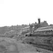 View from E showing SSE front of W block of ironworks with tenements in background