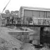 View from S showing men standing on footbridge with Firhill Iron Works in background