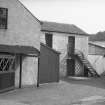 View looking ENE through entrance gate to mills