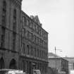 View from S showing ESE front of N block with part of S block of paint warehouses in foreground and Glasgow Copper Works in background