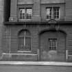 View from ESE showing blocked up entrance and date plaque on ESE front of Italian Renaissance block on Washington Street