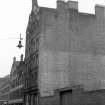 View from NE showing ESE front and part of NNE front of warehouse with saw mill in background