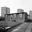 Scanned image of view from E with the Moredun high rise flats in the background.
'AIROH', prefabricated aluminium bungalow, Moredun area, Edinburgh (built 1949).