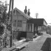 View from WNW showing NW and SW fronts of main station building with part of signal box in background