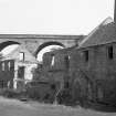View from W showing remains of mill with viaduct in background