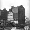 View from SE showing ESE and SSW fronts of E warehouse with part of W warehouse in background