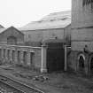 View from NW showing WNW front of N railway gate with works in background