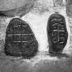 Two small slabs, bearing incised crosses.  
