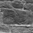 Fragment of Pictish symbol stone built into stone wall.
Original negative captioned: 'Sculptured Stone in Wall of Manse outhouses, Turriff July 1906'.
