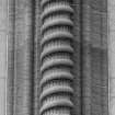 Detail of corbelled-out column above E entrance.