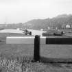 View looking WNW showing part of E lock gate with W lock gates and harbour in background