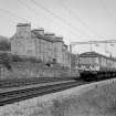 View looking E showing electric train approaching Bowling Station with tenement on left