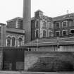 View from N showing part of chimney, main block and other blocks