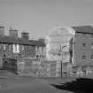 View from W showing WNW and WSW fronts of N block with part of numbers 4-12 St Cuthbert's Street on left