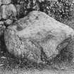 View of cup-marked stone, lying in front of dry-stane wall.