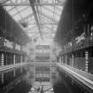 Interior view of the pool area showing trapeze and rings over pool, and changing rooms at side of pool in the Public Baths and Gymnasium, Primrose Street, Alloa.
