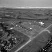 Scanned image of oblique aerial view showing part of the airport with Concorde on the apron.