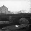 View from SW showing part of WSW front of bridge with mill in background