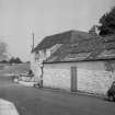 View from SW showing part of WNW front of building with mill in background