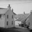 View from SE showing E front and part of S front of Shorehouse with part of Harbour Cottage in foreground