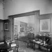 View from library into adjoining room with writing desk
