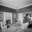 View of sitting room with plaster fireplace and glazed display cabinet
