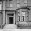 View of entrance front with mounting block at side of pavement below stairs
