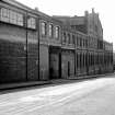 View from NW showing part of WSW front (Rigby Street front) of works with bridge in background