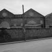 View from NW showing workshops behind wall