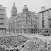 View from SSE showing part of SSW and ESE fronts of Coop warehouse with part of warehouse on left and tenement on right