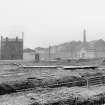 View from NE showing NNE front of tenement with Coop workshops and warehouses in background