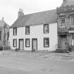 View from SE showing SSE front of The Saddlers with Church on left and Post Office on right