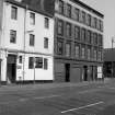 View from S showing ESE front of warehouse with part of 96 Commerce Street in foreground