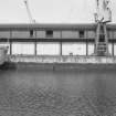 View from SSW showing cranes and part of SSW front of warehouses on N side of S basin with part of 'Lady Sofia' on left