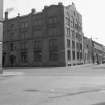 View from N showing WNW front and part of NNE front of works with doorway of depot in foreground