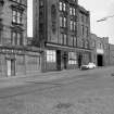 View from W showing WSW front of tenement and office with warehouse on right
