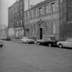 View from SW showing WNW front of paint works with numbers 60-64 Brown Street in background