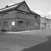 View from SSE showing ESE front and part of SSW front of E block with weaving sheds in background