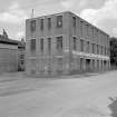 View from SSE showing S and E fronts of factory with part of 109 Reid Street on left