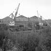 View from ESE showing part of ESE front of works with cranes in foreground