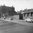 View from N showing ENE front of stationery works and numbers 22-16 with part of stables in foreground and offices in background