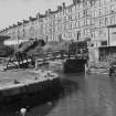 View from E showing ENE front of bascule bridge with tenements in background