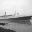 View looking SE showing QE II on River Clyde approaching Bowling with remains of pier in foreground