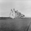 General view of side elevation with tennis court in foreground
