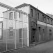 View from S showing part of ESE front of oil and grease works with cabinet works in background